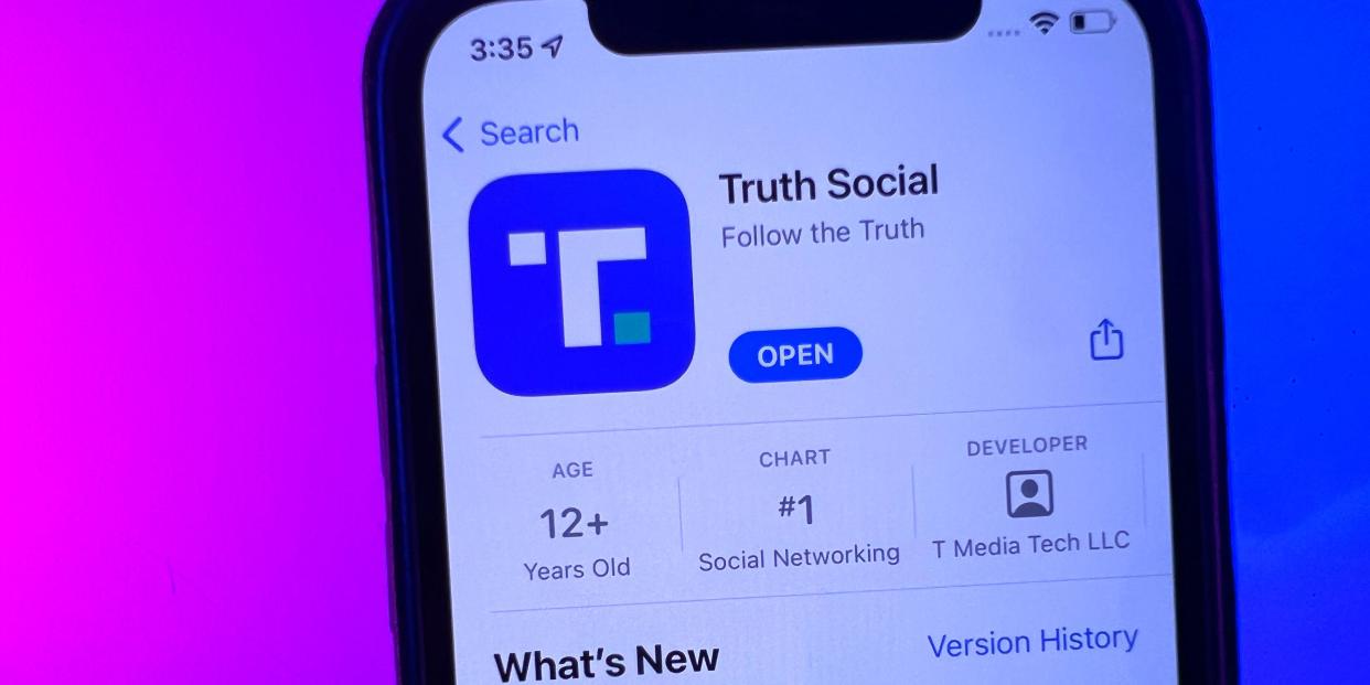 A phone displaying Donald Trump's Truth Social app in the Apple App Store.