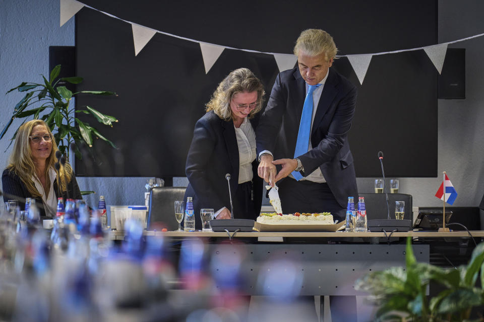 Far-right Party for Freedom leader Geert Wilders cuts a cake as he celebrates winning the most votes in a general election, in The Hague, Netherlands, Thursday Nov. 23, 2023. (AP Photo/Phil Nijhuis)