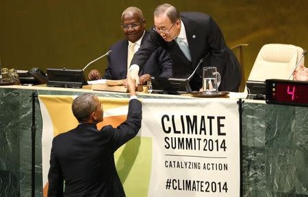 U.S. President Barack Obama (L) is greeted by United Nations Secretary-General Ban Ki-Moon (R) before addressing the Climate Summit at United Nations headquarters in New York, September 23, 2014. REUTERS/Kevin Lamarque