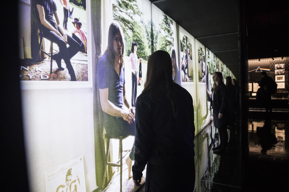 A museum worker looks at the cover of Pink Floyd’s 1969 album ‘Ummagumma’, at the V&A museum in west London, Tuesday, May 9, 2017, which shows a band member sitting, with a picture on the wall. The picture shows the same scene with a different band member and the effect continues for all four band members. - Credit: Joel Ryan/Invision/AP