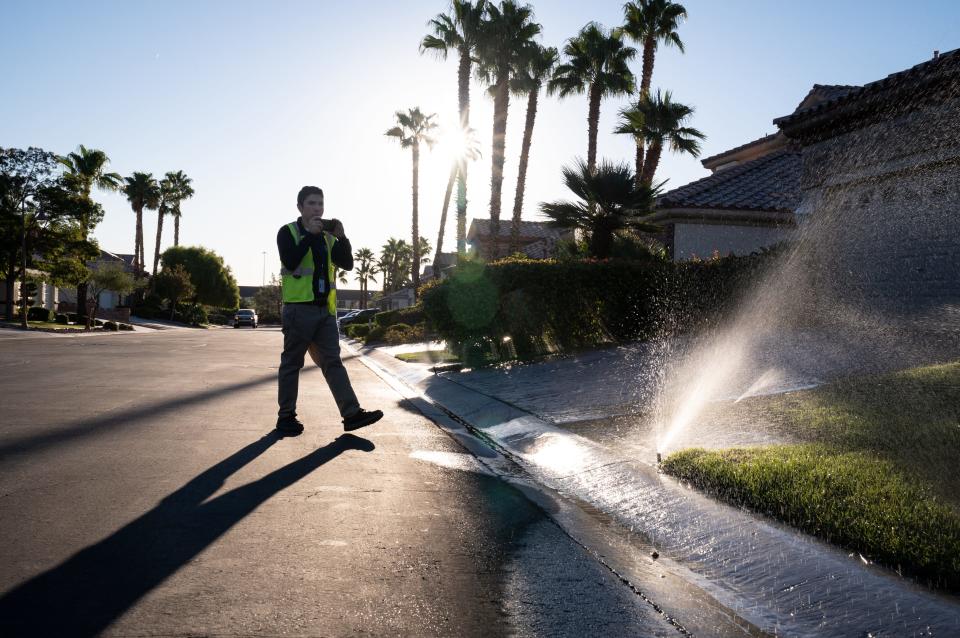 Water waste investigator Cameron Donnarumma of Las Vegas Valley Water District documents a violatio at a home in southwest Las Vegas on Sept. 27, 2022. Donnarumma issued a warning for water running off property and down the street.