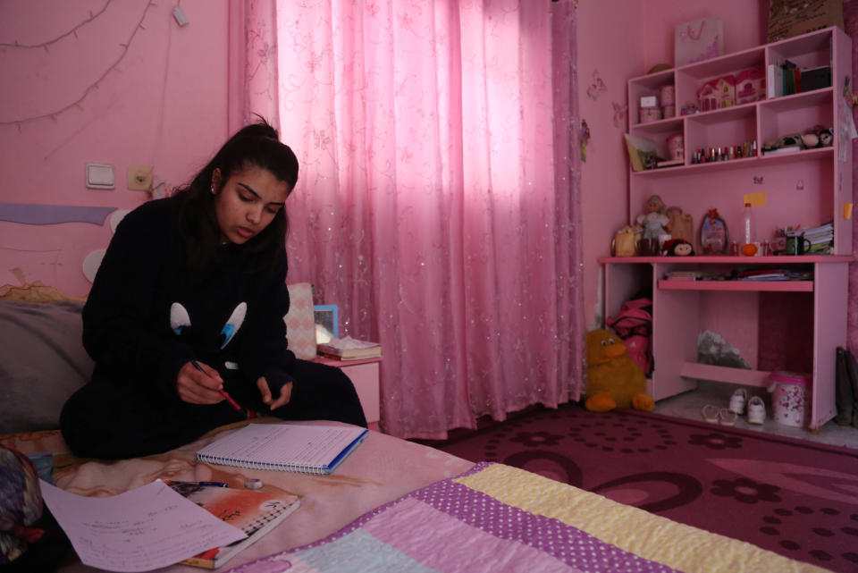 Fatma Youssef, 17, a Palestinian high school student and a horse rider, studies for school in her room in her family house in Gaza City, Feb. 7, 2019. "I'm nervous because this is my final high school year, but when I ride my horse I become free of stress," Youssef said. (Photo: Samar Abo Elouf/Reuters)    