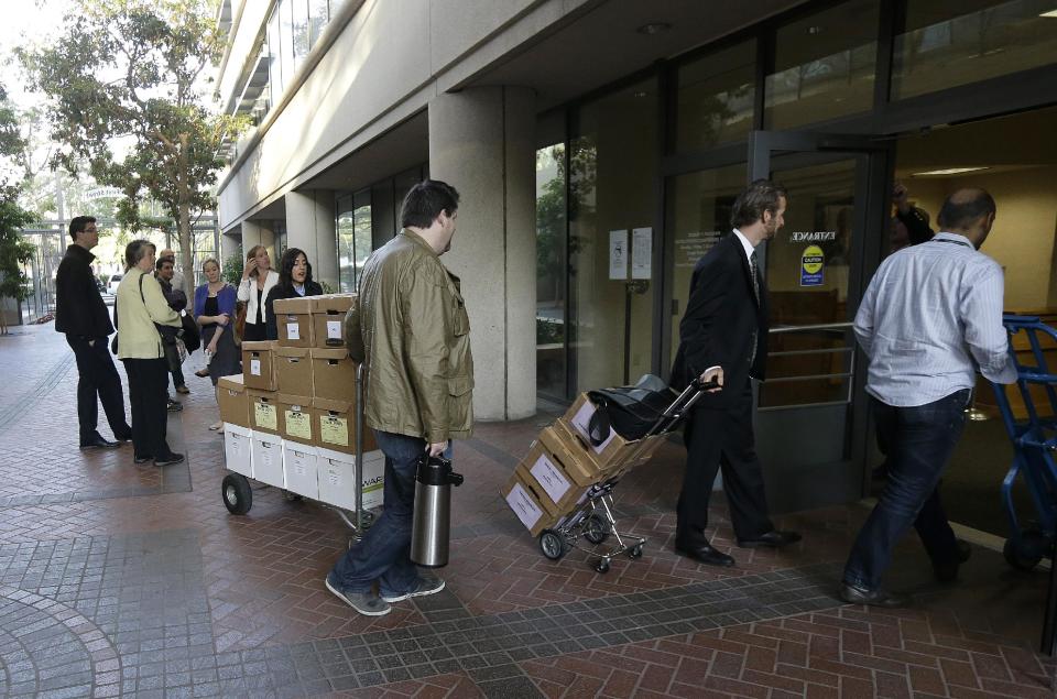 Boxes containing documents related to the Apple Inc. v. Samsung case are taken into a federal courthouse in San Jose, Calif., Tuesday, April 29, 2014. Lawyers for both companies are expected to deliver closing arguments Tuesday before jurors are sent behind closed doors to determine a verdict in a closely watched trial over the ownership of smartphone technology. (AP Photo/Jeff Chiu)