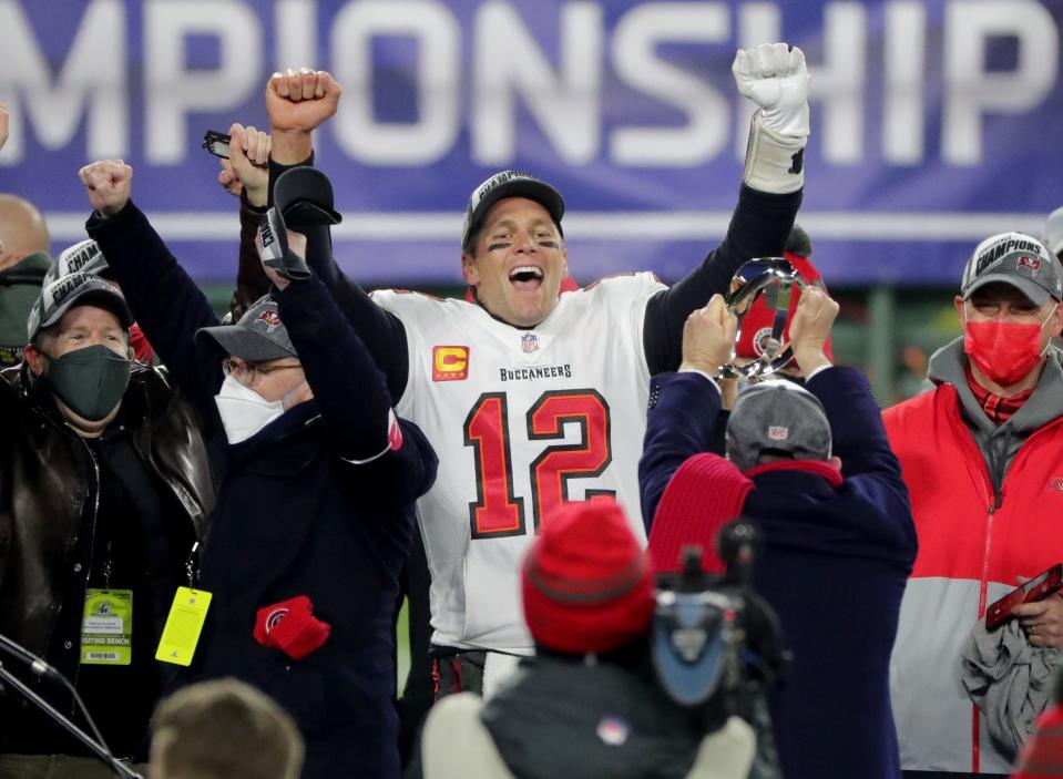 Jan 24: Tampa Bay Buccaneers quarterback Tom Brady celebrates during the presentation of the George Halas Trophy after  their NFC Championship Game against the Green Bay Packers.