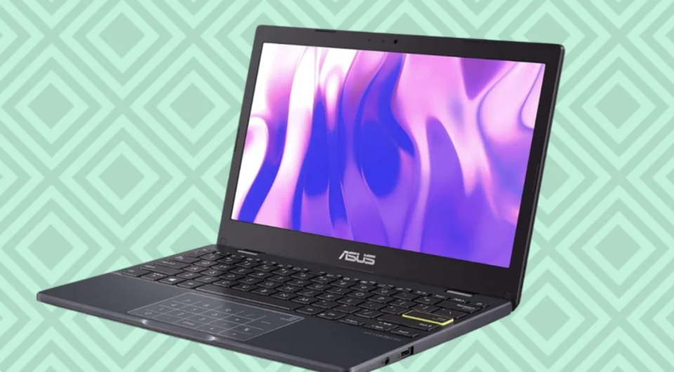 A black Asus laptop with a purple pattern image on the screen