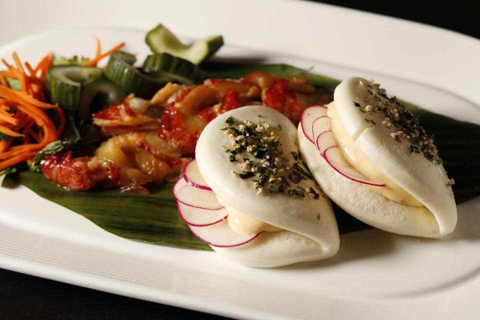 Pesca Vilano's Lobster Bao Buns: Butter poached lobster, herb salad, radishes, cucumbers, miso caramel in steamed buns.