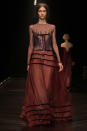 <b>LFW AW13: Marios Schwab </b><br><br>The designs included this stunning muted red gown.<br><br>© Getty