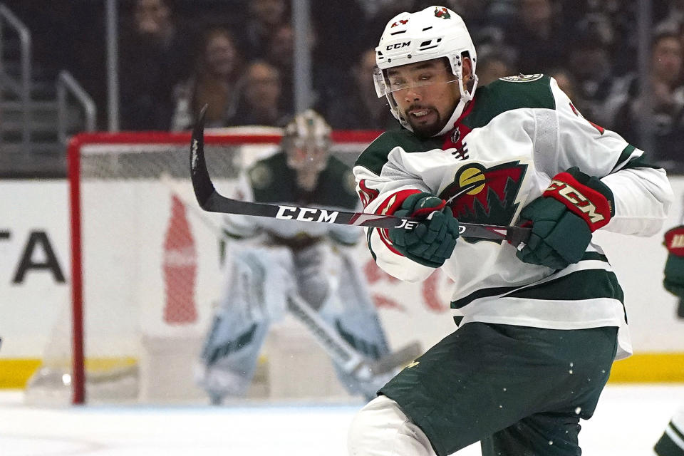FILE - In this Saturday, March 7, 2020, file photo, Minnesota Wild defenseman Matt Dumba passes the puck during the first period of an NHL hockey game against the Los Angeles Kings in Los Angeles. Bonding between veterans and youngsters has been a time-honored tradition in hockey. But in yet another setback related to the relentless COVID-19, NHL protocols aiming to curb the virus spread and keep the schedule on track could make that vital off-ice development of camaraderie more difficult. (AP Photo/Mark J. Terrill, File)