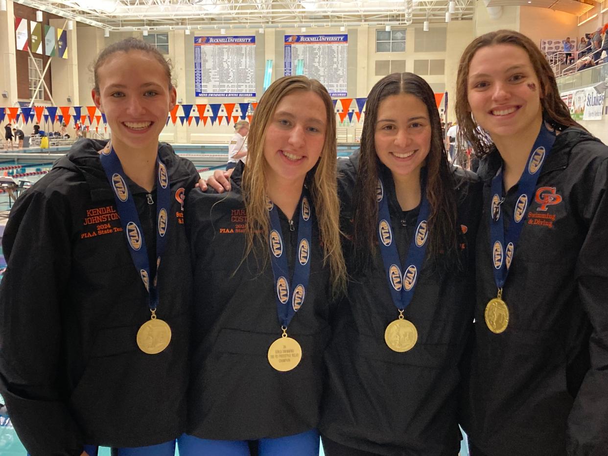 The Cathedral Prep quartet of (left to right) Kendal Johnston, Maria Costa, Jaslene Cage and Josie Dufala pose with the gold medals they received for winning the Class 2A girls 200-yard freestyle relay final during Friday's PIAA swimming and diving meet at Bucknell University's Kinney Natatorium in Lewisburg.
