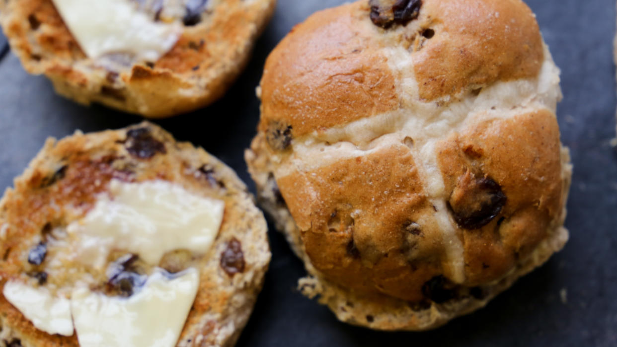  Hot cross buns spread with butter. 