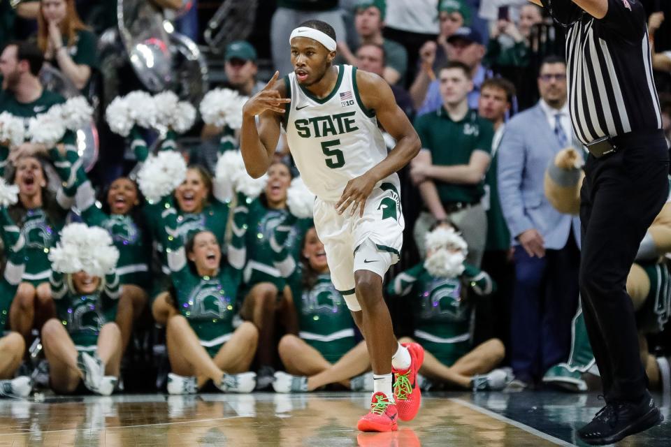 Michigan State guard Tre Holloman (5) celebrates a three point basket against Northwestern during the first half at Breslin Center in East Lansing on Wednesday, March 6, 2024.