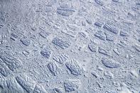 <p>Icebergs and sea ice, as seen from NASA’s Operation IceBridge research aircraft, float off the coast of the Antarctic Peninsula region, on Nov. 3, 2017, above Antarctica. (Photo: Mario Tama/Getty Images) </p>