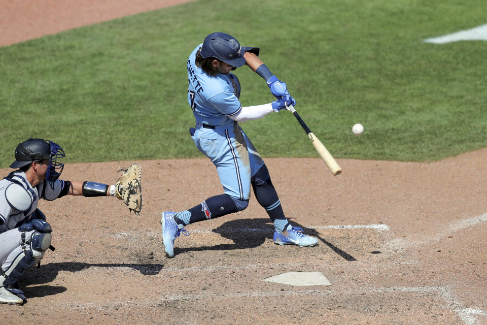 Toronto Blue Jays' Bo Bichette connects on a game-winning home run in front of New York Yankees catcher Kyle Higashioka during the ninth inning of a baseball game Wednesday, April 14, 2021, in Dunedin, Fla. The Blue Jays won 5-4. (AP Photo/Mike Carlson)