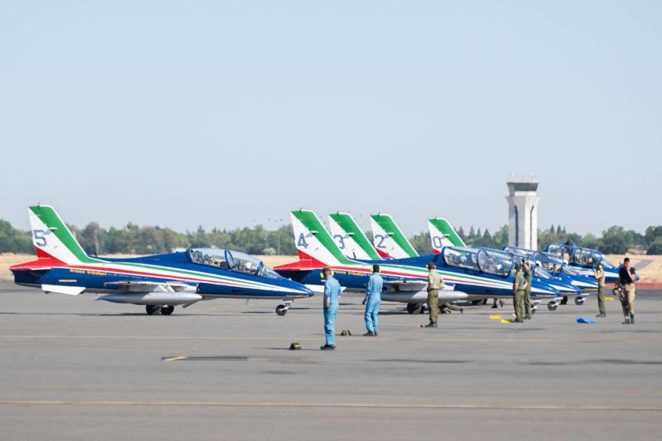 Pilots of Frecce Tricolori, the Italian air force’s aerobatic team, park their jets at Mather Airport near Rancho Cordova on Tuesday. A crowd of onlookers greeted them with cheers and applause upon their landing. The team is performing in the California Capital Airshow for the first time.