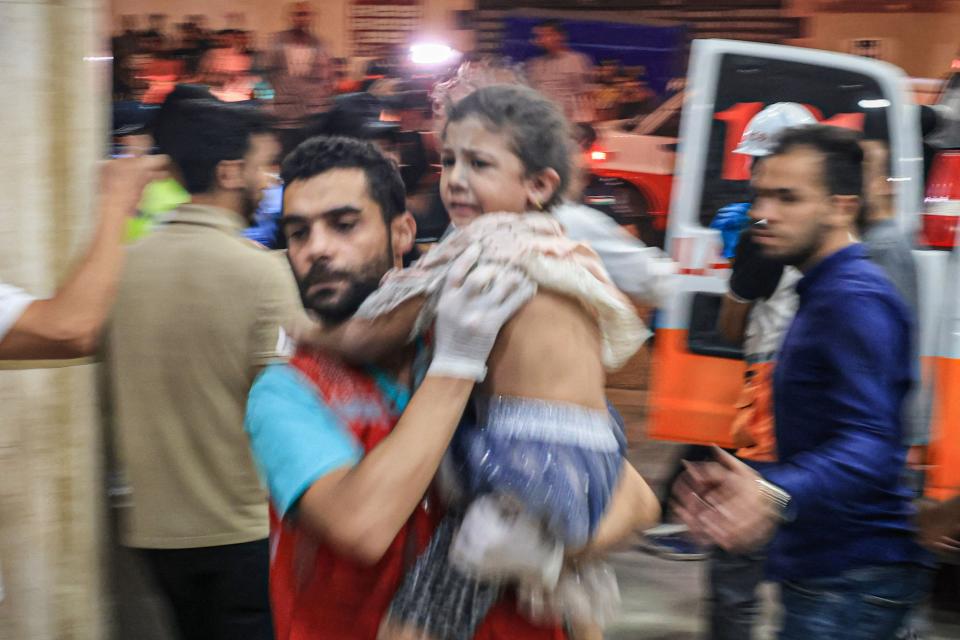 A Palestinian child is carried inside the Nasser hospital in Khan Yunis in the southern of Gaza Strip, on October 17, 2023.