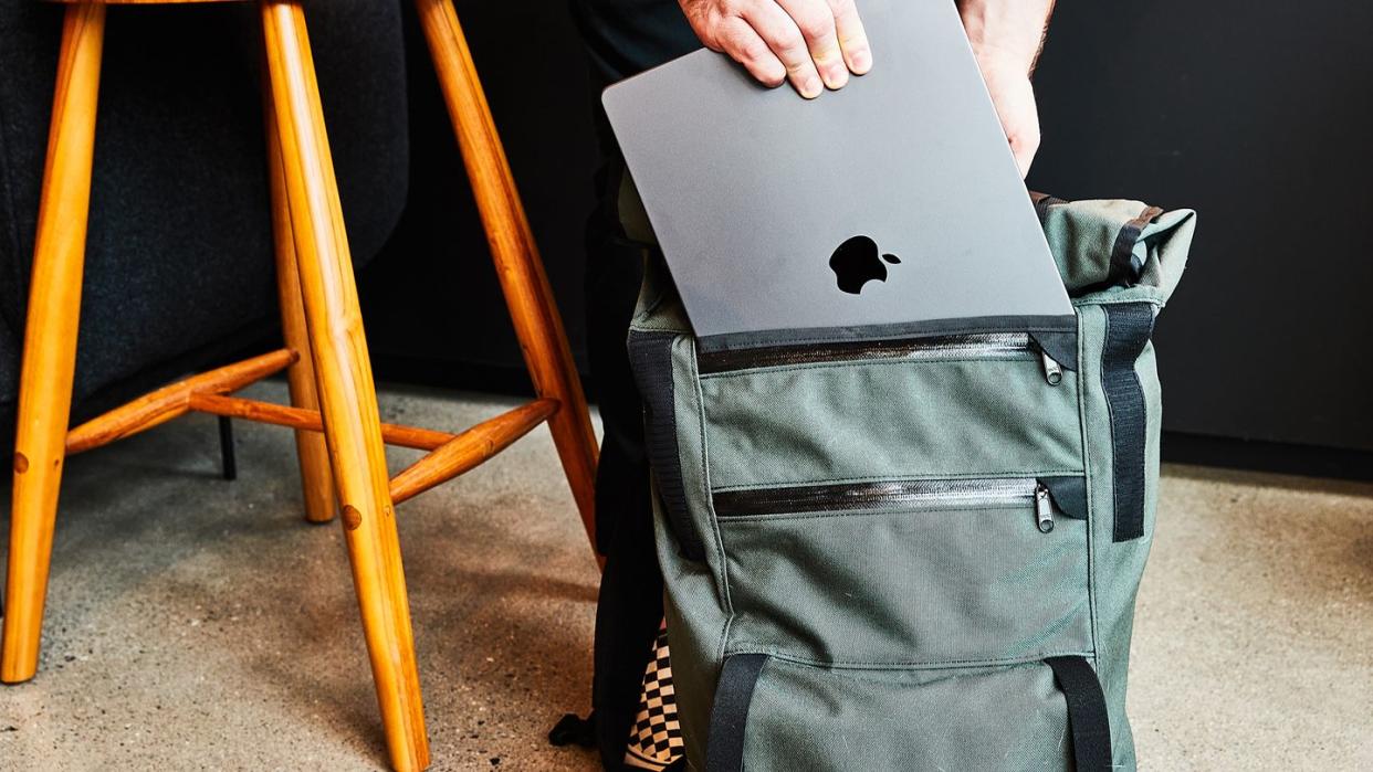 a person holding a laptop