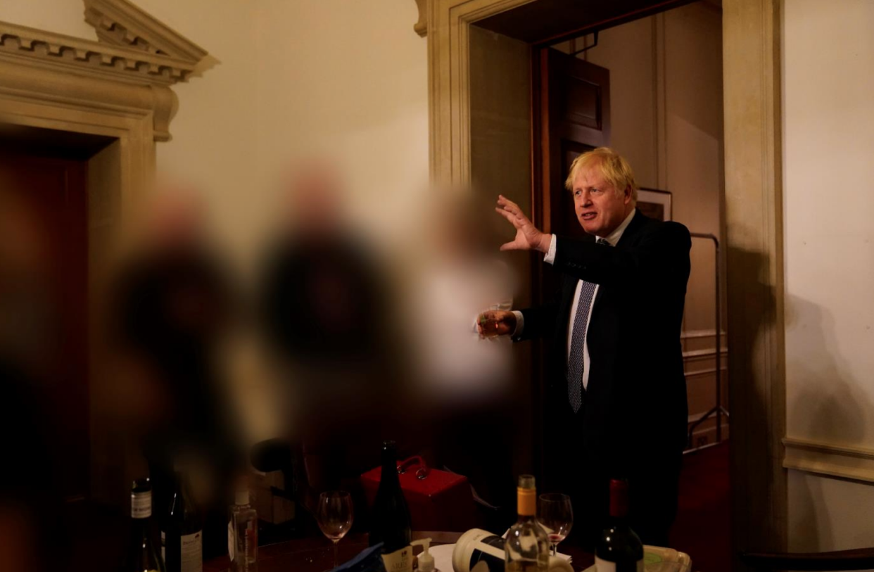 Boris Johnson holding a drink at Lee Cain's leaving event at Downing Street on 13 November, 2020. (Cabinet Office)