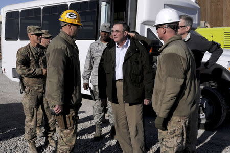 Jon Rymer (C), inspector general for the U.S. Department of Defense, greets senior leaders from the Fort Bragg, North Carolina-based 82nd Sustainment Brigade-U.S. Central Command Materiel Recovery Element and engineers from the Little, Rock, Arkansas-based 489th Engineer Battalion during a tour of a deconstruction site on Kandahar Airfield, Afghanistan, in this handout photograph taken on January 11, 2014 and obtained on May 15, 2015. REUTERS/Sgt. 1st Class Jon Cupp, 82nd SB-CMRE Public Affairs/U.S. Army/Handout via Reuters