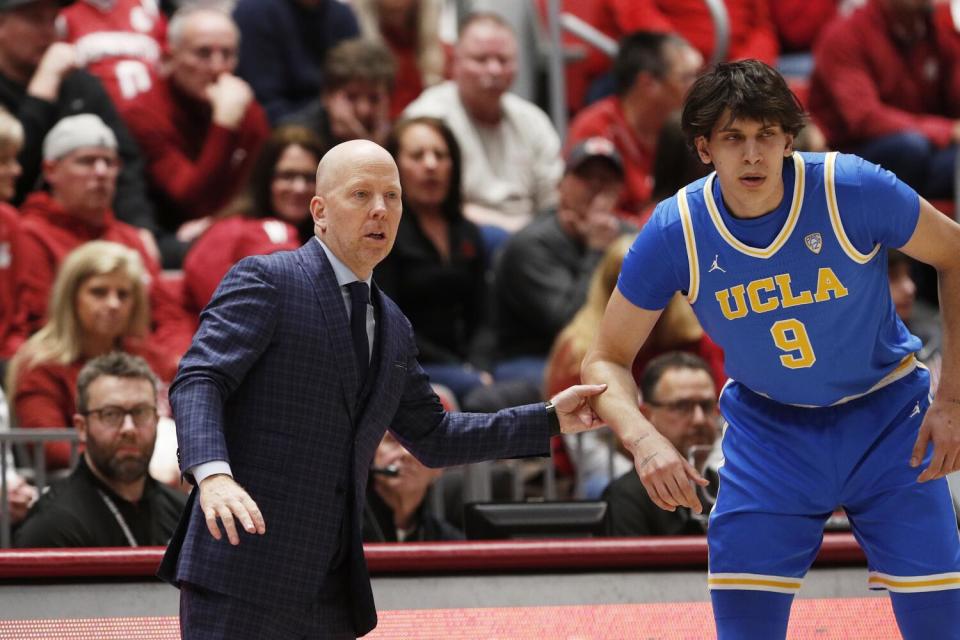 UCLA coach Mick Cronin speaks with forward Berke Buyuktuncel during a game against Washington State on March 2