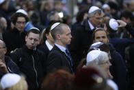 FILE - In this Wednesday, April 25, 2018 file photo, people wear Jewish skullcaps, as they attend a demonstration against an anti-Semitic attack in Berlin. As Jews around the world gather Sunday night to mark the beginning of Yom Kippur, many in Germany remain uneasy about going together to their houses of worship to pray, a year after a white-supremacist targeted a synagogue in the eastern city of Halle on the holiest day in Judaism. (AP Photo/Markus Schreiber, file)
