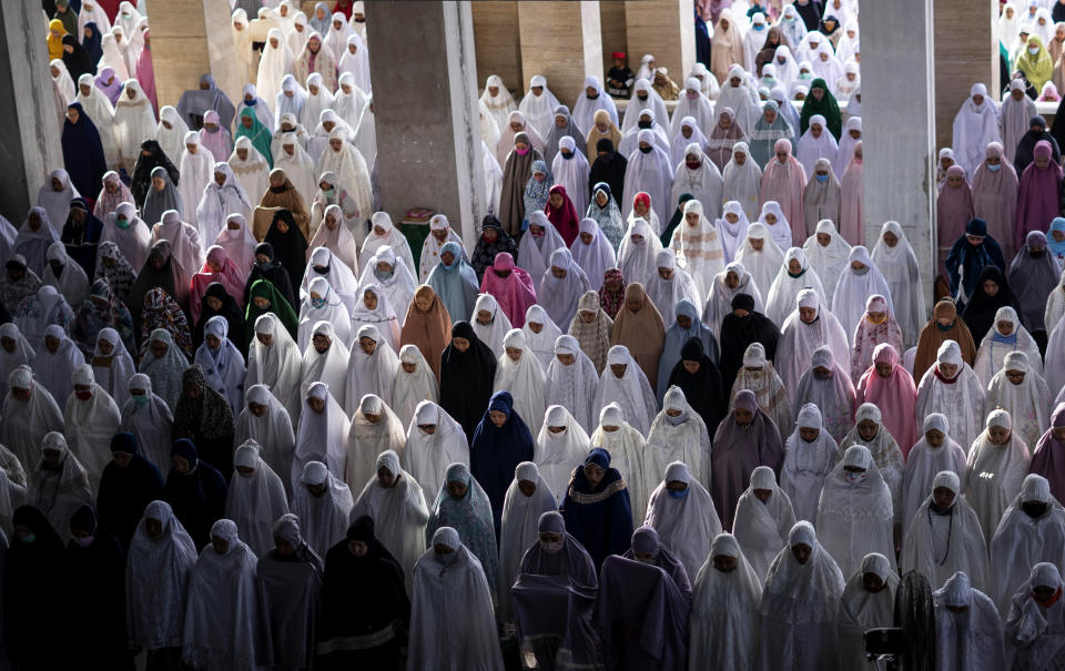 Muslim women perform during an Eid al Fitr prayer despite concerns of the new coronavirus outbreak, at a mosque in Lhokseumawe in the deeply conservative Aceh province, Indonesia, Sunday, May 24, 2020. Millions of people in the world's largest Muslim nation are marking a muted and gloomy religious festival of Eid al-Fitr, the end of the fasting month of Ramadan - a usually joyous three-day celebration that has been significantly toned down as coronavirus cases soar. (AP Photo/Zik Maulana)