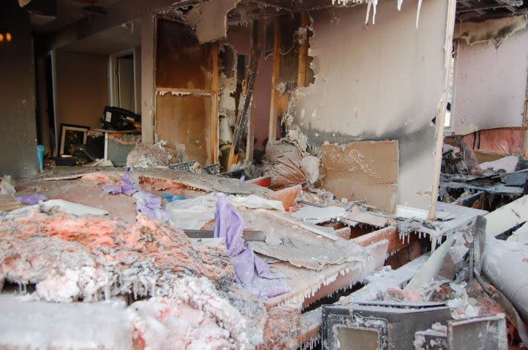 The first floor living room in the front right corner of the home on Dagenais Drive, where the wood stove was located. 