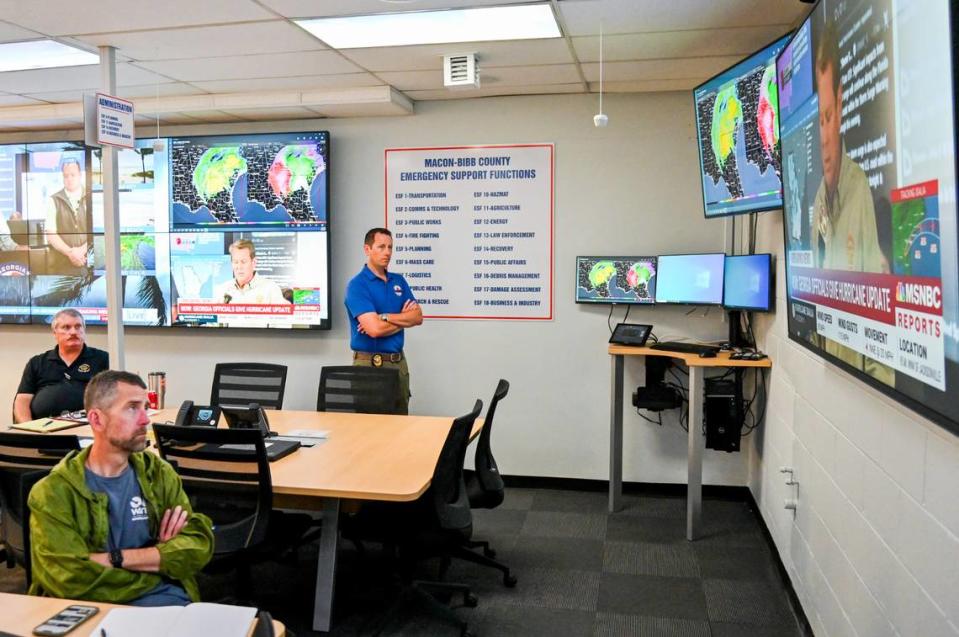 Macon-Bibb EMA Director Spencer Hawkins, center, watches Gov. Brian Kemp’s press conference on Hurricane Idalia Wednesday inside the emergency agency’s bunker in downtown Macon.