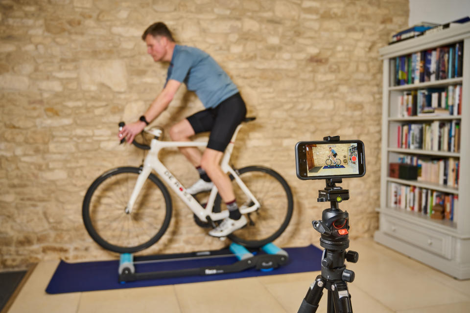 Simon Fellows filming himself riding on rollers for an AI bike fit