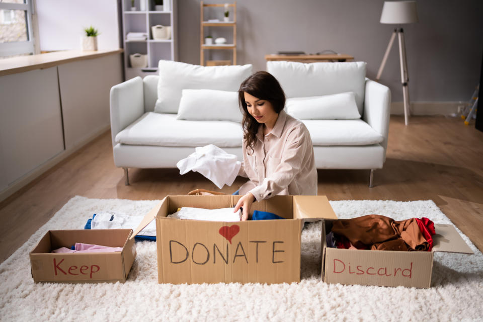 Woman decluttering her home. (Getty Images)