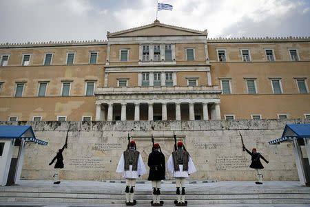 Greek Presidential guards perform during a change of shift at the Tomb of the Unknown Soldier in Athens February 18, 2015. REUTERS/Alkis Konstantinidis