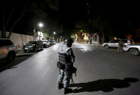 An Afghan policeman keeps watch near the site of an attack in Kabul, Afghanistan early May 27, 2015. REUTERS/Mohammad Ismail