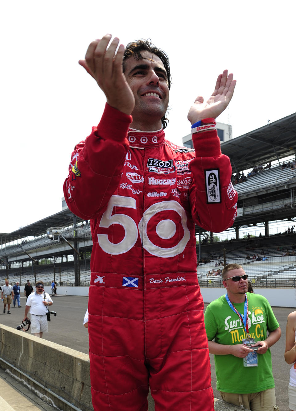 INDIANAPOLIS, IN - MAY 25: Dario Franchitti of Scotland, driver of the #50 Target Chip Ganassi Racing Dallara Honda, celebrates as his teamate Scott Dixon of New Zealand, driver of the #9 Target Chip Ganassi Dallara Honda, wins his semi final round during the pit stop challenge on Carb Day for the Indianapolis 500 on May 25, 2012 at the Indianapolis Motor Speedway in Indianapolis, Indiana. (Photo by Robert Laberge/Getty Images)