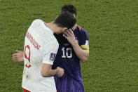 Poland's Robert Lewandowski, left, interacts with Argentina's Lionel Messi at the end of the World Cup group C soccer match between Poland and Argentina at the Stadium 974 in Doha, Qatar, Wednesday, Nov. 30, 2022. (AP Photo/Hassan Ammar)