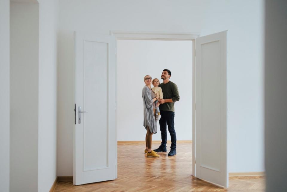 View of couple with child through doorway.