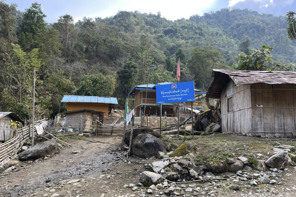 This early 2022 photo provided by Global Witness shows a sign for the New Democratic Party – Kachin in the village of Labang in the Kachin state of Myanmar. Notorious Kachin militia leader Zakhung Ting Ying is a patron of the party, which was founded in 2019. Zakhung Ting Ying runs the area along the Myanmar-Kachin border, where mining is taking place, as a fiefdom. The sign reads "New Democracy Party (Kachin), Maung Zone village, Chipwi township, Kachin state." (Global Witness via AP)