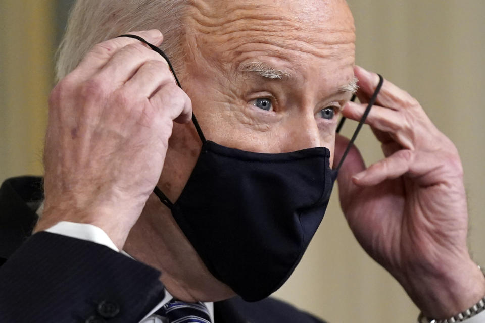 President Joe Biden puts on his face mask after speaking about the COVID-19 relief package in the State Dining Room of the White House, Monday, March 15, 2021, in Washington. (AP Photo/Patrick Semansky)