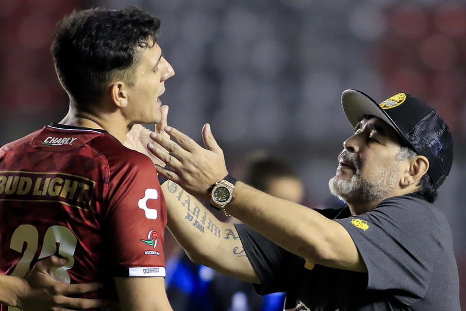 QUERETARO, MEXICO - SEPTEMBER 26: Coach of Dorados Diego Armando Maradona calms down Gaspar Servio of Dorados during a match between Queretaro and Dorados as part of Round of eighth of Copa MX Apertura 2018at Corregidora Stadium on September 26, 2018 in Queretaro, Mexico. (Photo by Jam Media/Getty Images)