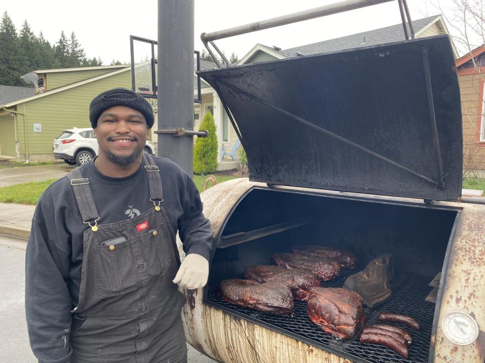 Trebriel "Briel" Larry of Briel's BBQ cooking up brisket, pork loin and sausage.