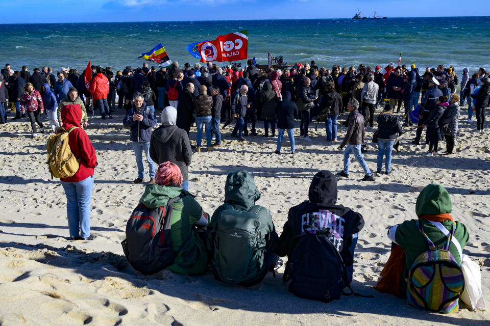 People march in solidarity with the families of the victims of a deadly shipwreck, in Cutro, southern Italy, Saturday, March 11, 2023. The known death toll from the shipwreck climbed to 76 on Saturday after the bodies of two children and an adult were recovered, Italian news agency ANSA reported. (AP Photo/Valeria Ferraro)