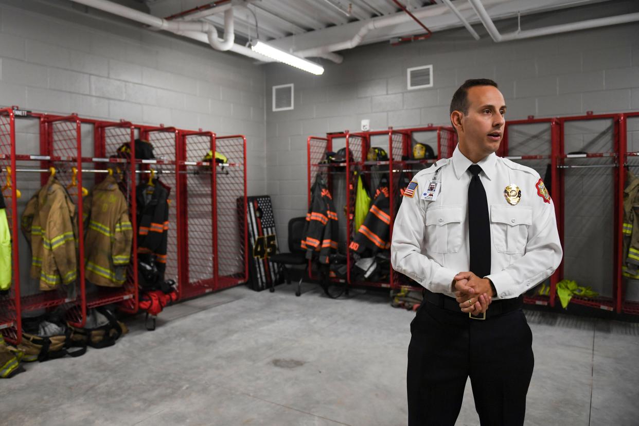 Fire Marshall John Centrone, shows off the storage room for firefighters' gear at the new fire station headquarters on Friday, April 19. 2024.