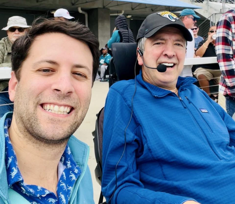 Alex Litt (left) and his father Marc (right), a cardiologist for more than 30 years at Baptist Health, attend a Jaguars game together. Litt and a friend, Cory Sullivan, will play 100 holes in golf on June 19 in Austin, Texas to raise awareness for ALS, which his father is battling.