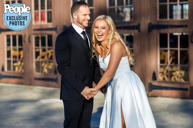 <p>Ben Wagner Photography</p> Cristy Lee and husband John Hawkins hold hands at their wedding
