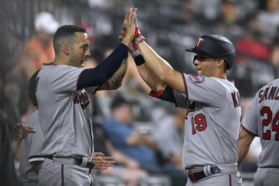 Minnesota Twins' Alex Kirilloff (19) celebrates with Carlos Correa at the dugout after hitting a two-run home run during the seventh inning of the team's baseball game against the Chicago White Sox on Tuesday, July 5, 2022, in Chicago. (AP Photo/Paul Beaty)