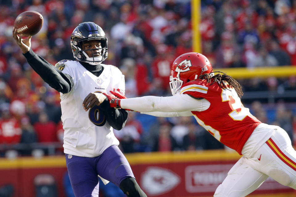 Baltimore Ravens quarterback Lamar Jackson, left, throws under pressure from Kansas City Chiefs safety Ron Parker (38) during the second half of an NFL football game in Kansas City, Mo., Sunday, Dec. 9, 2018. (AP Photo/Charlie Riedel)