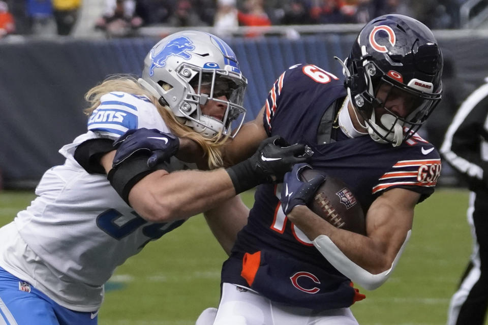 Chicago Bears wide receiver Equanimeous St. Brown (19) tries to break the tackle of Detroit Lions linebacker Alex Anzalone (34) during the first half of an NFL football game in Chicago, Sunday, Nov. 13, 2022. (AP Photo/Charles Rex Arbogast)