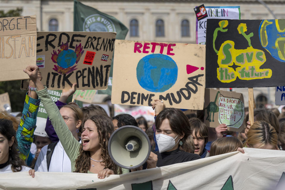 Climate activists attend a demonstration in Berlin, Friday, Sept. 23, 2022. Youth activists staged a coordinated “global climate strike” on Friday to highlight their fears about the effects of global warming and demand more aid for poor countries hit by wild weather. (Monika Skolimowska/dpa via AP)