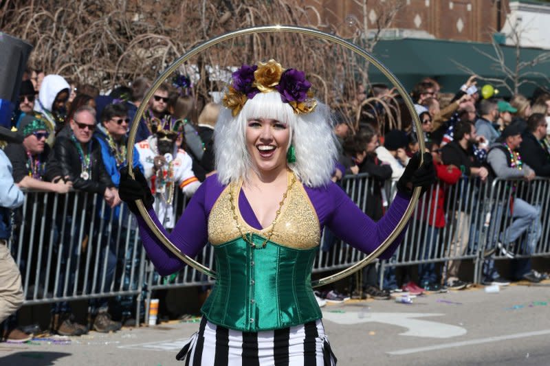 A woman performs with a Hula Hoop as she walks in the St. Louis Mardi Gras Parade on February 22. Photo by Bill Greenblatt/UPI