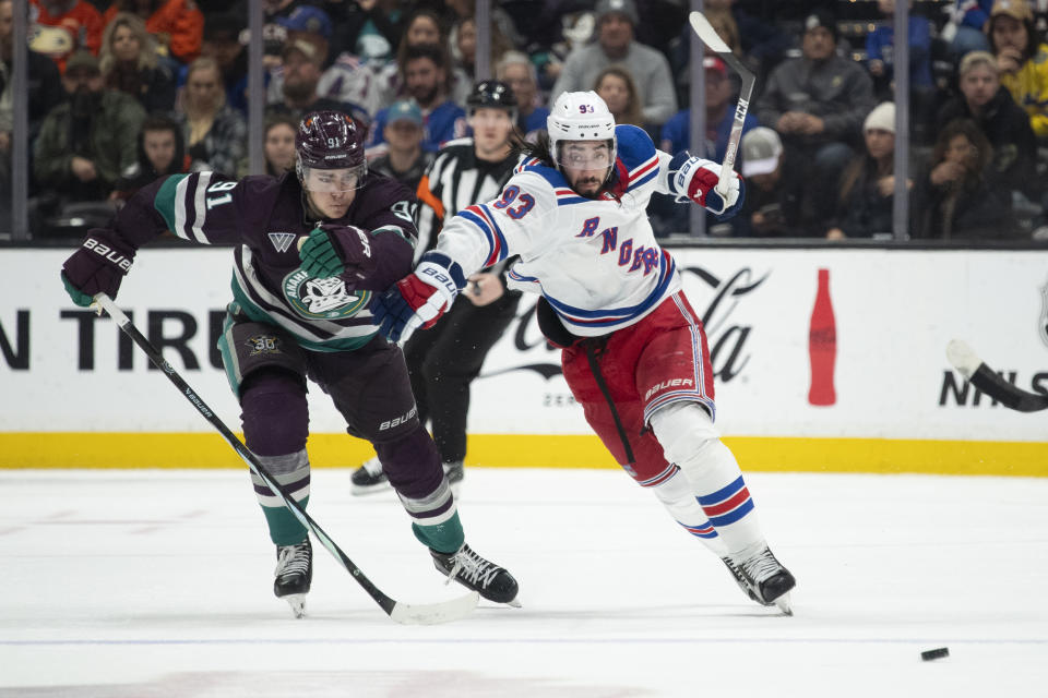 New York Rangers center Mika Zibanejad (93) and Anaheim Ducks center Leo Carlsson (91) vie for the puck during the second period of an NHL hockey game, Sunday, Jan. 21, 2024, in Anaheim, Calif. (AP Photo/Kyusung Gong)