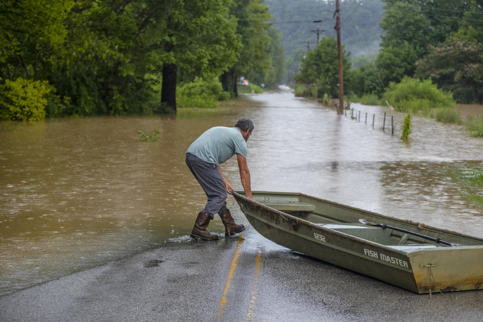 A man prepares to launch a boat near flooded Wolverine Road in Breathitt County, Ky., on Thursday, July 28, 2022. Heavy rains have caused flash flooding and mudslides as storms pound parts of central Appalachia. Kentucky Gov. Andy Beshear says it's some of the worst flooding in state history. (Ryan C. Hermens/Lexington Herald-Leader via AP)