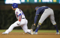 Chicago Cubs' Willson Contreras, left, reacts after sliding into second base safely with a double ahead of a tag from Milwaukee Brewers' Jonathan Schoop during the fifth inning of a baseball game Monday, Sept. 10, 2018, in Chicago. (AP Photo/Jim Young)